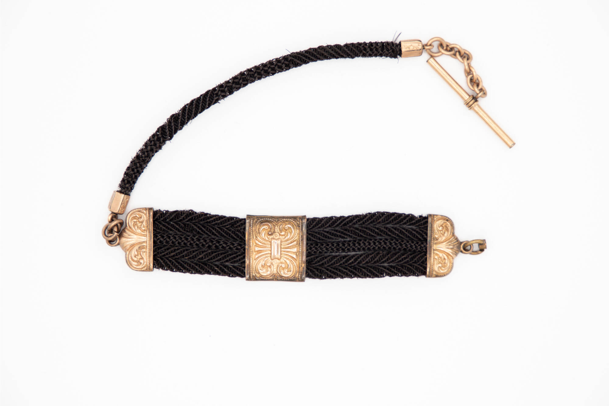 Bracelet made out of woven hair and metal clasps.